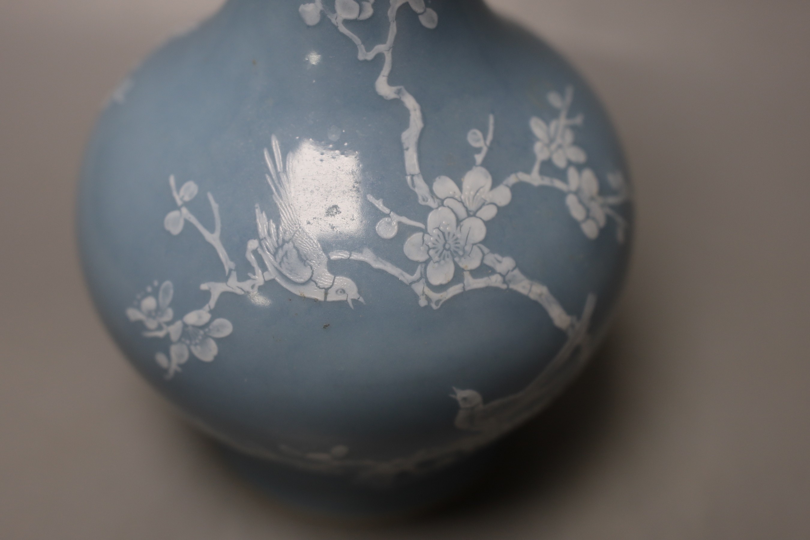 A Chinese claire de lune glazed white slip decorated vase - 25cm high